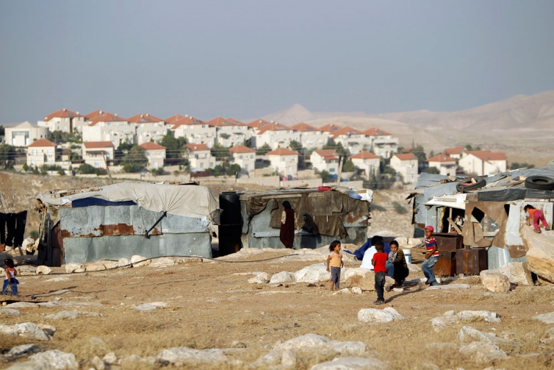 Children of the Jahalin tribe. Israel plans to expel the area’s Bedouin villagers to expand the settlement of Ma’ale Adumim (background). Photo: ‘Ammar ‘Awad, Reuters, 16 June 2012