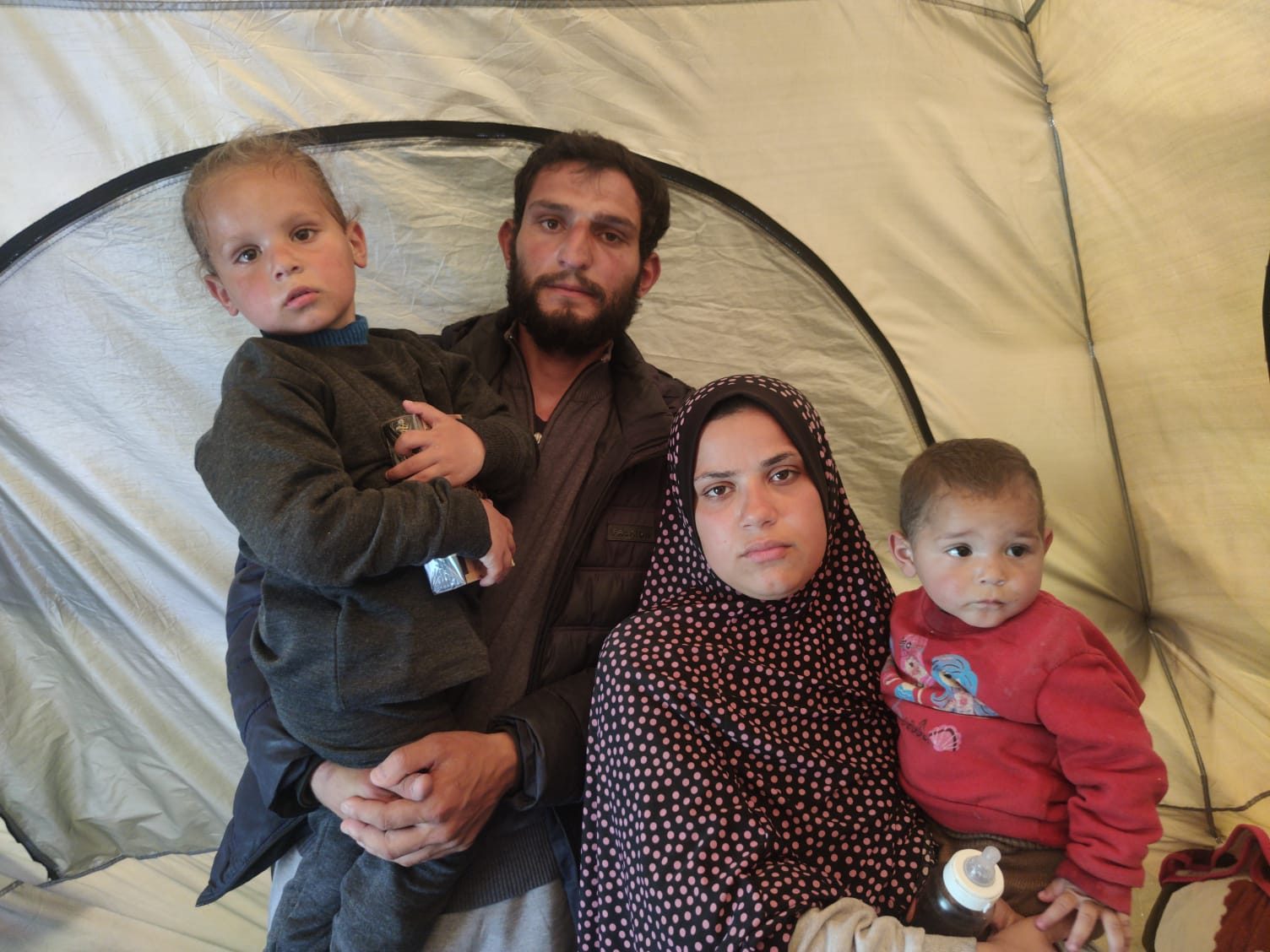 Hadil a-Dahduh Zaza with her husband Rushdi Zaza and their children Muhammed and Zein after her release. Photo by Olfat Al-Kurd, B'Tselem, 18 March 2024